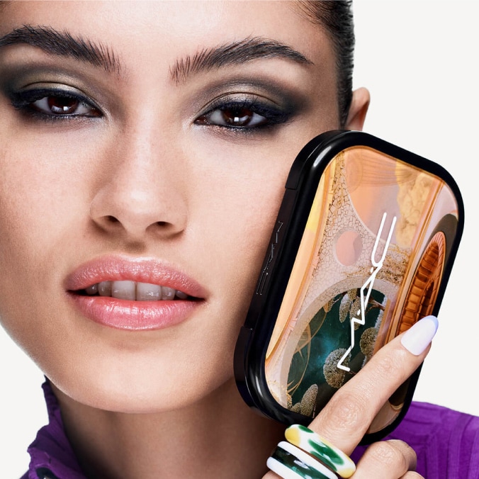Model with MAC Cosmetics product.